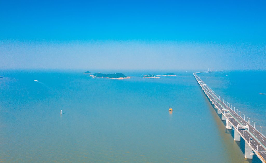 Essa ponte liga o território de Hong Kong ao de Macau, ambas regiões administrativas da China. Possui um rígido sistema de circulação, além de pedágios.  Sua extensão é de aproximadamente 55 km, com um trecho de 6,7 km de túnel submerso, onde navios poderão transitar sobre.